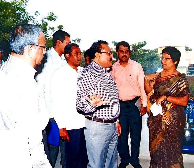 Officials and community members in a field consultation