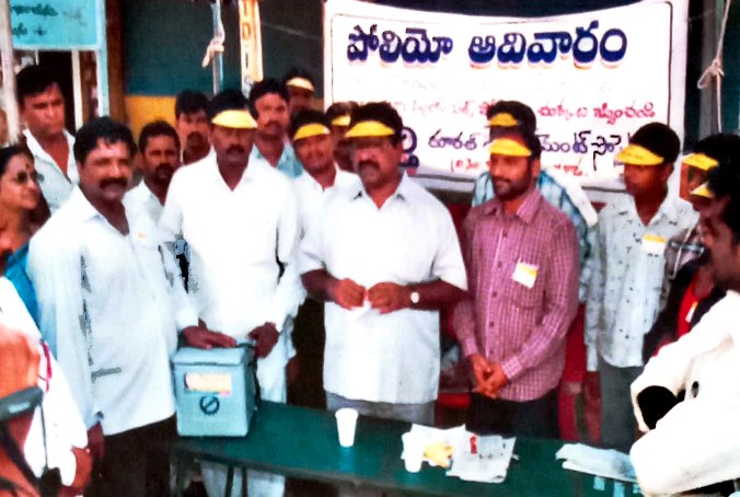 Polio prevention campaign team with vaccine carrier